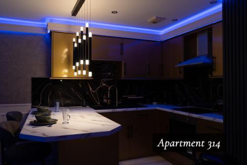 a kitchen with aendant light hanging over a counter at The Opulence Bradford in Bradford