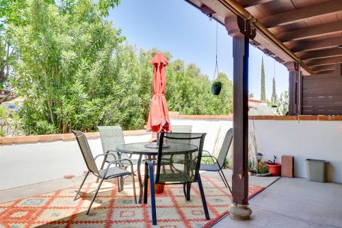 a patio with a table and chairs and an umbrella at Green Valley Vacation Rental with Community Pools! in Green Valley