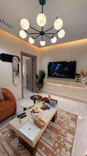 a living room with a couch and a table at سكاي لاين سويت in Jeddah
