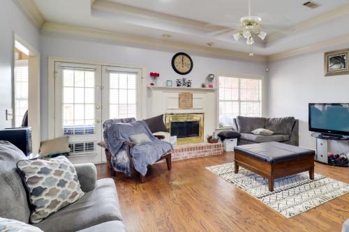 a living room with couches and a fireplace at Spacious Suburban Home with Pool Access in Ridgeland in Ridgeland