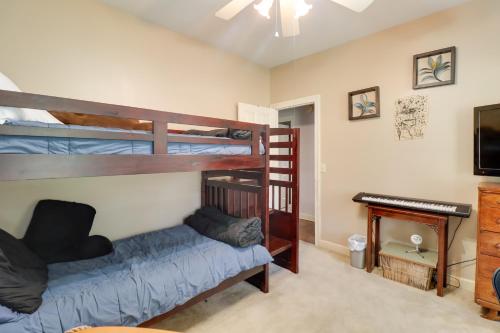 a bedroom with two bunk beds and a piano at Spacious Suburban Home with Pool Access in Ridgeland in Ridgeland