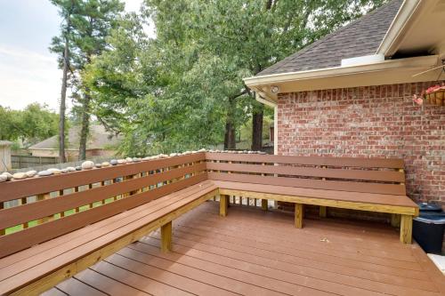 a wooden bench sitting on a wooden deck at Spacious Suburban Home with Pool Access in Ridgeland in Ridgeland