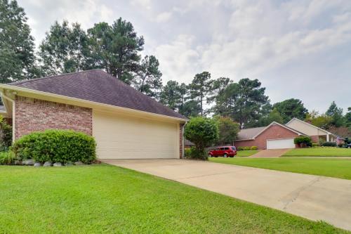 a house with a garage and a driveway at Spacious Suburban Home with Pool Access in Ridgeland in Ridgeland