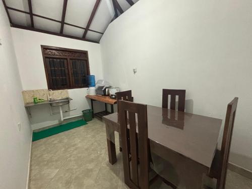 a dining room with a table and a sink at Solara Holiday Homes in Anuradhapura