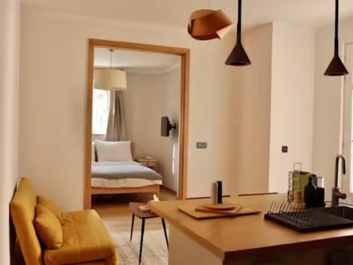 Zimmer mit einem Schreibtisch und einem Schlafzimmer mit einem Bett. in der Unterkunft Dandy Downtown Apt in Budapest