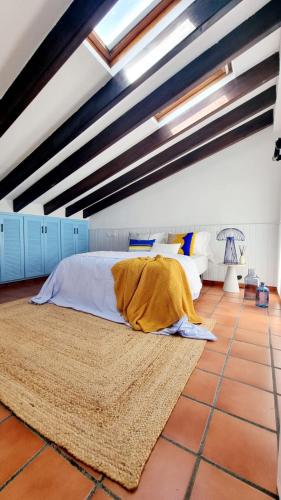 a bedroom with a large bed on a tiled floor at Villa Blue beach Tabarca in Tabarca