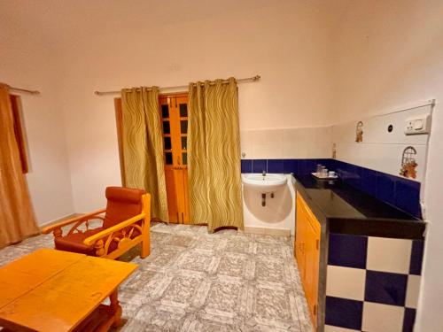 a kitchen with a sink and a toilet in a room at Dreamy vibe Stays in Morjim