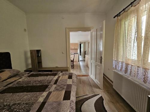 a bedroom with a bed and a hallway at Apartman Knez 644 in Valjevo