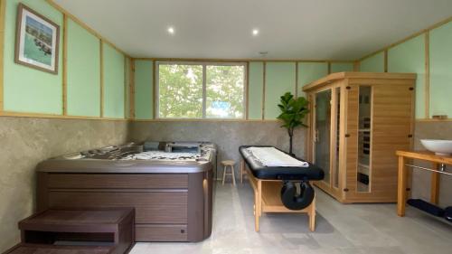 a room with a bed and a table and a stool at Gîte de Moulins in Cubnezais