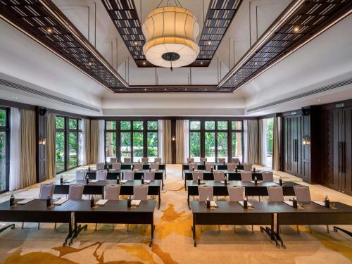 a large room with desks and chairs in a room with windows at Mövenpick Asara Resort & Spa Hua Hin in Hua Hin