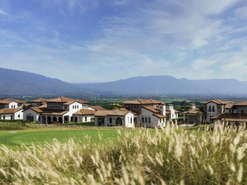 a group of houses on a golf course at Mövenpick Resort Khao Yai in Ban Wang Sai