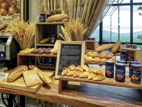 a bakery display with bread and other baked goods at Mövenpick Resort Khao Yai in Ban Wang Sai
