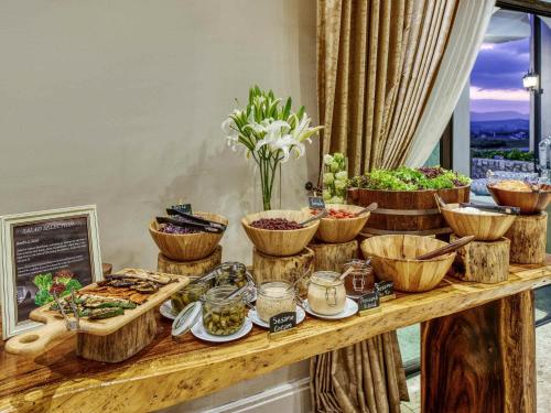 a buffet with bowls of food on a table at Mövenpick Resort Khao Yai in Ban Wang Sai