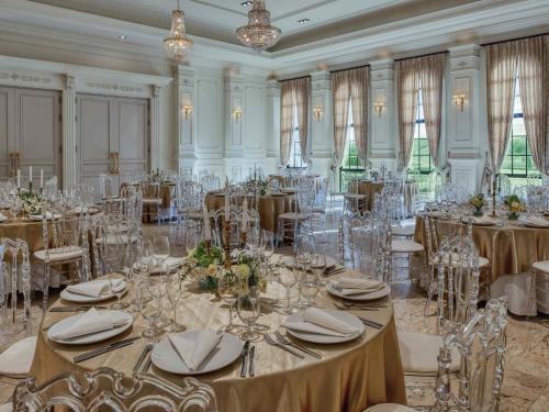 a ballroom with tables and chairs with tablesktop at Mövenpick Resort Khao Yai in Ban Wang Sai