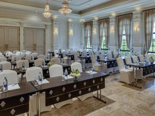 a large room with tables and chairs in a room at Mövenpick Resort Khao Yai in Ban Wang Sai