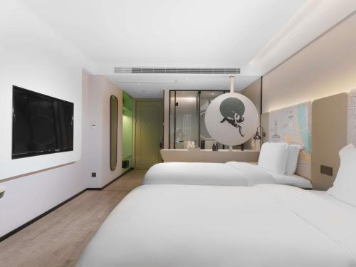 Ένα ή περισσότερα κρεβάτια σε δωμάτιο στο Mercure Chengdu Xindu