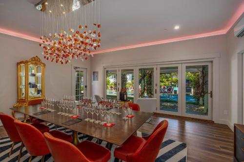 a large dining room with a long table and red chairs at White House Napa in Napa