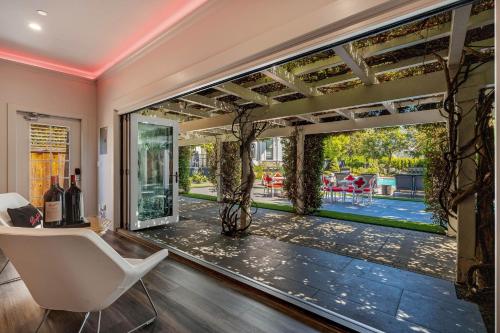 a living room with a large window with a view of a yard at White House Napa in Napa