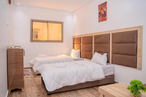 a bedroom with two beds and a window at Tifawine Stay Guest House Social Stay and Oceanview Rooms in Imsouane