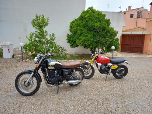 two motorcycles are parked next to each other at Oasi Ottocento in Quartu SantʼElena