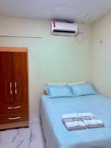 a bedroom with a bed with a dresser and a heater at FLAT -Apartamento na Pedreira Belém in Belém