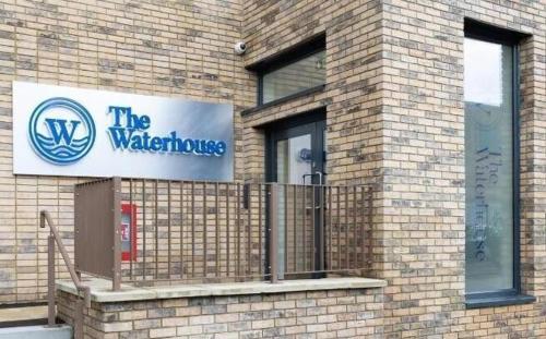 a brick building with a sign for the waterkeepers at Luxury Mcr 2bed,2bath Apartment- Central location! in Manchester