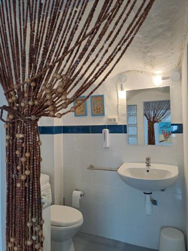 a bathroom with a sink and a toilet at El Cap de Pedra in Calles