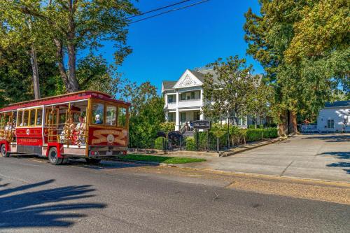 a red trolley car driving down a street at White House Napa in Napa
