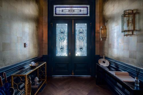 a room with a door with a window and a table at White House Napa in Napa