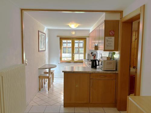a kitchen with a counter top and a microwave at Chalet Medi in Zermatt