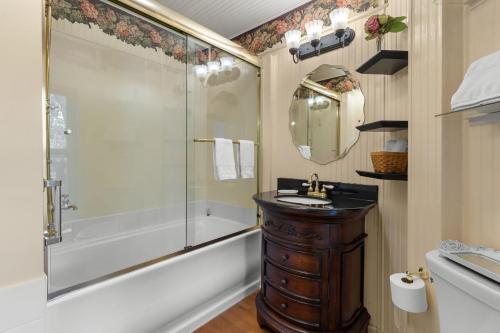 a bathroom with a sink and a shower and a mirror at McTernan Manor in Franklin