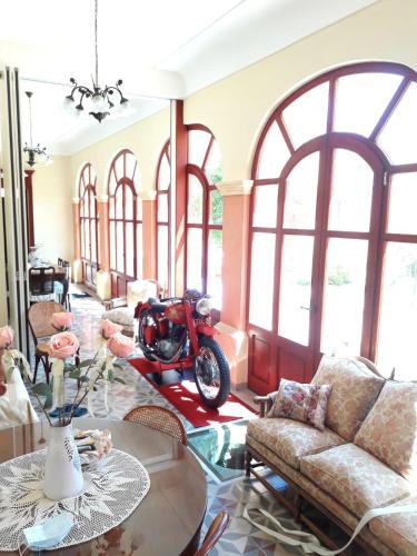 a living room with a motorcycle parked in a room at Oasi Ottocento in Quartu SantʼElena