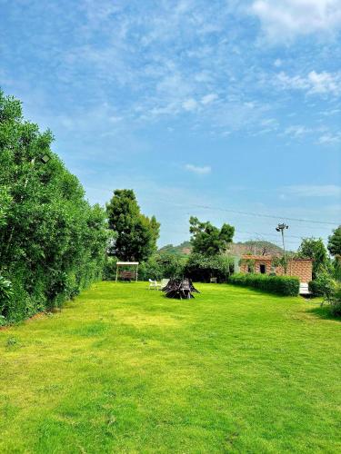 a field of green grass with a soccer ball at Radha Kunj Resort Pushkar in Pushkar