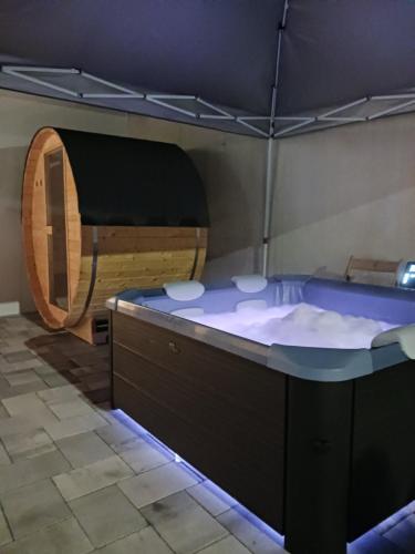 a jacuzzi tub in a room with a wooden at Casa La Familia in Posušje