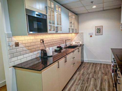 a kitchen with a sink and a counter top at La Buena Vida Holiday Homes - Modern, Luxe & Spacious 4-Bed, Full Kitchen, near to Beach, Tram & Marina in Dubai