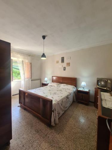 a bedroom with a large bed and a window at La Corte del Tadde in Lammari