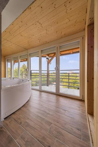 a large bathroom with a tub and large windows at Forty One Luxury Spa in Belgrade