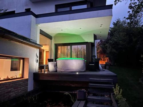 a house with a green light on the back of it at Rózsás Vendégház in Szólád