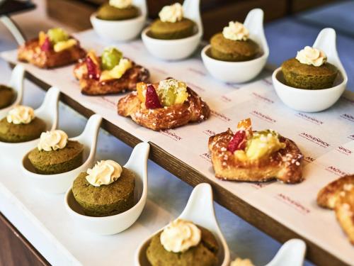 a display case filled with mini desserts in little spoons at Mövenpick Villas & Residences Phu Quoc in Phu Quoc