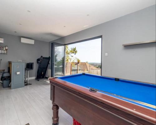 a pool table in a room with a view at Close to QA hospital, Portsmouth Naval Cottage with incredible views in Portsmouth