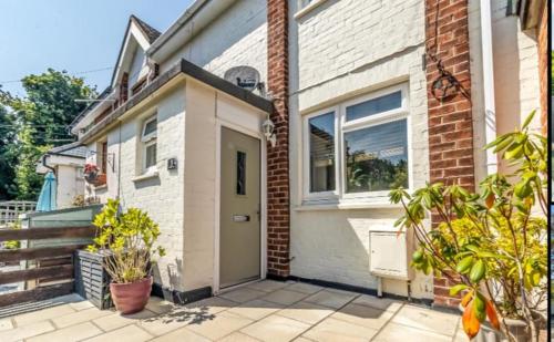 a brick house with a door and a window at Close to QA hospital, Portsmouth Naval Cottage with incredible views in Portsmouth