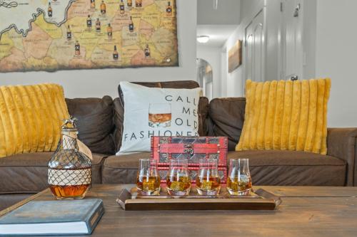 a coffee table with a tray of wine glasses on it at Shelbyville Farmhouse with Hot Tub, Fire Pit and Grill in Shelbyville