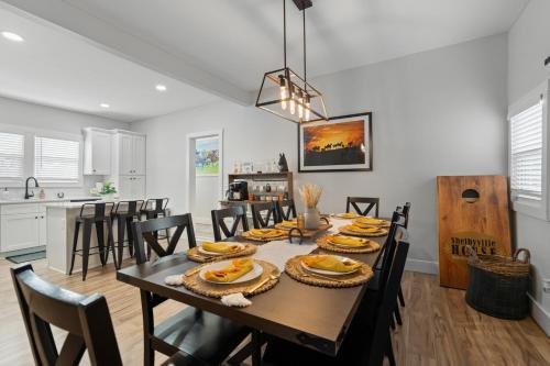 a dining room and kitchen with a table and chairs at Shelbyville Farmhouse with Hot Tub, Fire Pit and Grill in Shelbyville