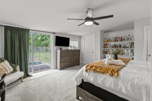 a bedroom with a bed and a ceiling fan at Shelbyville Farmhouse with Hot Tub, Fire Pit and Grill in Shelbyville