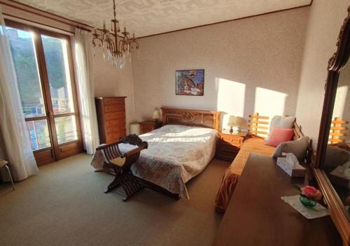 a bedroom with a bed and a chair in it at Fra Dolcino in Pray