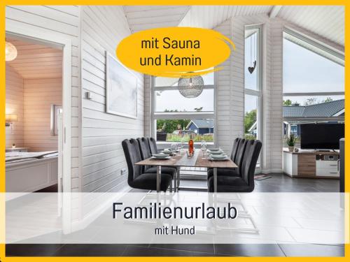 a kitchen and dining room with a table and chairs at Ferienhaus Küstenzauber Kalifornien - mit Hund - komplett eingezäunter großer Garten - Sauna und Kamin - im Sommer Strandkorb inklusive in Schönberg in Holstein