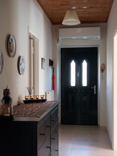 a kitchen with a black door and a black counter at Karamaniko in Episkopí