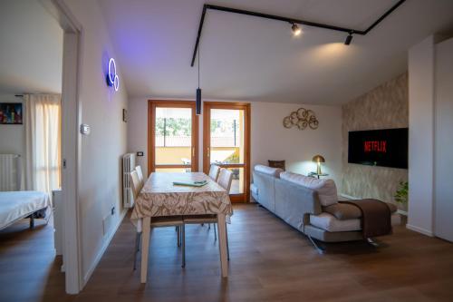 a living room with a couch and a table at La Coccola by Andrea in Castelfranco Emilia