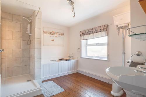 a bathroom with a shower and a sink at Woodcocks in Docking