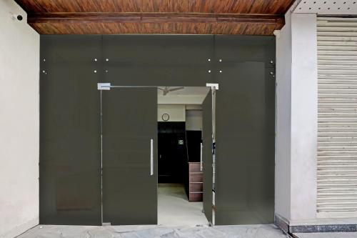 a large glass door to a hallway in a building at Hotel O Shiridi Residency in Vidya Nagar